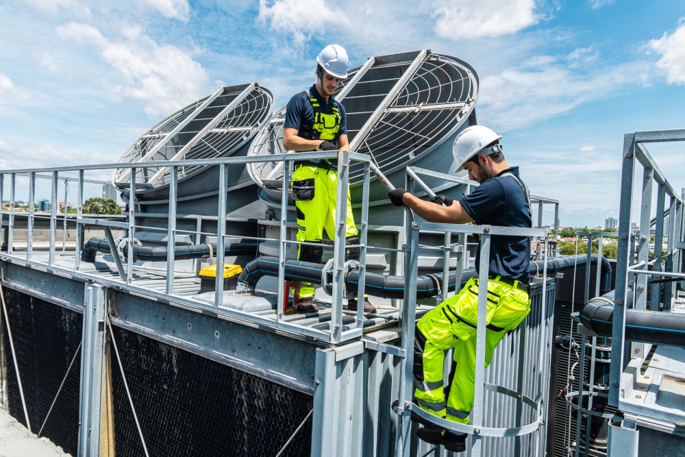 Industrial HVAC and refrigeration equipment with technicians performing maintenance